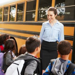 school-teacher-preparing-kids-to-get-on-the-school-bus.jpg